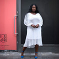 Load image into Gallery viewer, Women's Plus Size Aphrodite White Holiday Resort Dress with a white undergarment, paired with blue heels for a chic urban look