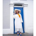 Load image into Gallery viewer, Women's Plus Size Aphrodite White Holiday Resort Dress with a white undergarment, paired with a white sunhat, the Cherry Blossom Silk Scarf and blue heels.