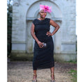 Load image into Gallery viewer, Women's Boudicca Summer Black Ruched Bodycon dress styled with a pink hairpiece, black and gold clutch, and gold chain black heels for a stylish look.