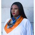 Load image into Gallery viewer, Silk scarf with Orange Bird of Paradise and White-Blue Cherry Blossom print, styled around model's neck over a white blouse for a chic look.