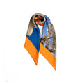 Load image into Gallery viewer, Silk scarf showcasing an Orange Bird of Paradise with White and Blue Cherry Blossom print, displayed as a cutout to highlight its intricate design.