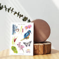 Load image into Gallery viewer, Eco-friendly A5 sticker sheet with kingfisher and lily illustrations