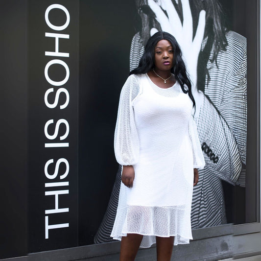 Women's Plus Size Aphrodite White Holiday Resort Dress with a white undergarment, showing a chic urban look.