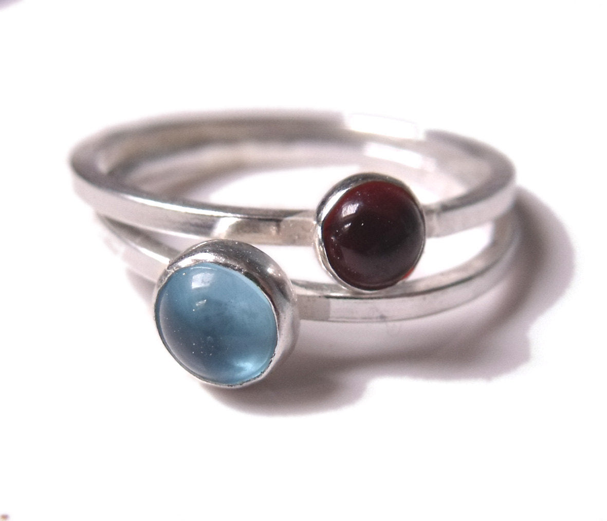 set of two sterling silver Blue Topaz and garnet stacking rings